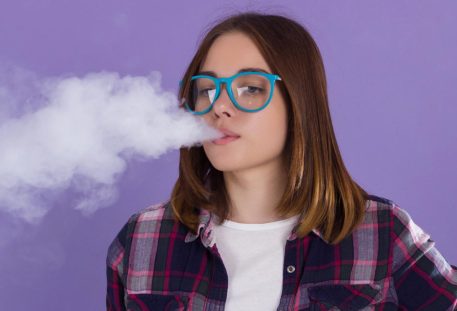 Young pretty girl with electronic cigarette. Vaping girl background cigarette woman young electronic vape